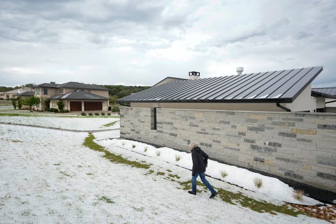 Rick Hitz walks in his hail-covered yard in the Belvedere neighborhood on Hamilton Pool Road near Bee Cave Wednesday March 27, 2024. “I just moved from Alaska to get away from this,” he said.